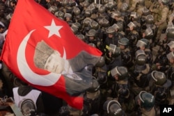 Turkish police try to push back protesters trying to enter a courthouse where prosecutors were to deliver final arguments in a trial against nearly 300 people accused of plotting to overthrow the government, in Silivri near Istanbul. Turkey, December 13, 2012.