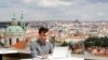 FILE - Joseph Petrila, a 23-year-old job seeker, uses a laptop in a cafe near the Prague Castle following the coronavirus outbreak, in Prague, Czech Republic, July 8, 2020. 