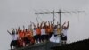 FILE - Inmates at the Puraquequara prison stand on a water tower as they protest against bad conditions and restrictions on family visits put in place to curb the spread of the new coronavirus, in Manaus, Brazil, May 2, 2020. 