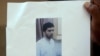  Indian man holds a copy of handout pictures released by the police showing Indian Mujahideen operative and alleged mastermind of the July 2011 Mumbai serial blasts, Yasin Bhatkal, at a press conference in Mumbai.
