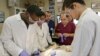 A group of students work on a dead body in the anatomy lab at the medical school at Indiana University Northwest.