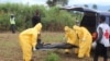 Health workers carry the body of an Ebola virus victim in the Waterloo district of Freetown, Liberia, Oct. 21, 2014. 