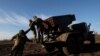 Ukranian service members prerpare to lauch rockets in the Bakhmut region