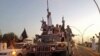 FILE - Fighters from the Islamic State group parade in a commandeered Iraqi security forces vehicle in Mosul, Iraq.