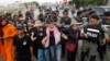 Cambodian civil rights supporters are forcibly directed by riot police as they march in protest of charges brought against local rights activists near Prey Sar prison, outside Phnom Penh, Cambodia, May 9, 2016. 