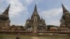 FILE - Tourists walk at the ruins of the ancient capital of Ayutthaya, Thailand.