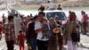 Displaced people from the minority Yazidi sect, fleeing violence in the Iraqi town of Sinjar, re-enter Iraq from Syria at the Iraqi-Syrian border crossing in Fishkhabour, Dohuk province, Aug. 10, 2014.