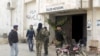 FILE - Rebel fighters stand outside Idlib museum in Idlib, Syria, after Islamist rebel fighters took control of the area, April 1, 2015. 