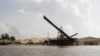 This Aug. 2, 2011 photo shows a sand depot just outside the provincial capital of Koh Kong in southwestern Cambodia. It is owned by Ly Yong Phat, one of the country's biggest tycoons who is being criticized for the environmental damage his sand mining operations inflict on the Cambodian coast. Most of the sand is destined for Singapore. (AP Photo/Heng Sinith)