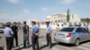 FILE - Investigators, interior ministry officers and members of security forces gather near the site of a bomb blast outside the Chinese Embassy in Bishkek, Kyrgyzstan, Aug. 30, 2016.