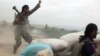 FILE - An Afghan National Army soldier (L) shouts at Taliban fighters, after firing a rocket towards Taliban positions, on the outskirts of Kunduz, northern Afghanistan, April 16, 2016.