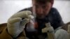 FILE - A scientist separates blood from plasma cells to isolate any Ebola RNA to test for the virus at the European Mobile Laboratory in Gueckedou, Guinea.
