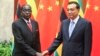 Zimbabwean President Robert Mugabe, left, and Chinese Premier Li Keqiang pose for photographers prior to their meeting at the Great Hall of the People in Beijing, Aug. 26, 2014. 