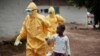Health workers accompany a nine-year-old who contracted the Ebola virus to a Monrovia treatment center on Sept. 30, 2014.