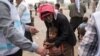 FILE - A displaced boy, who fled the violence in Mosul, receives a measles vaccination from a UNICEF-supported health worker in Hamdaniyah, Iraq, Oct. 24, 2016.