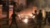FILE - This June 10, 2018, picture shows protesters burning motorcycles in front of a provincial office in Vietnam's south central coast Binh Thuan province in response to legislation on three special economic zones that would grant 99-year leases to comp