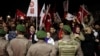Pro-secular demonstrators wait for the release of former army chief Ilker Basbug outside the Silivri prison complex near Istanbul, Turkey, March 7, 2014.