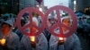 People attend a candlelight vigil wishing for a successful summit between the U.S. and North Korea, in front of the U.S. embassy in central Seoul, South Korea, June 9, 2018.