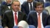 Turkey's president-elect Recep Tayyip Erdogan (L) and Foreign Minister Ahmet Davutoglu sit together during a party meeting in Ankara, Turkey, Aug. 21, 2014.