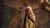 A young Somali girl stands outside her makeshift hut at a camp in Qardho, Somalia, March 9, 2017.