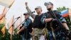 FILE - Self-styled governor of Luhansk region Valery Bolotov (C) delivers a speech during a rally to mark and celebrate the announcement of the results of the referendum on the status of Luhansk region in Luhansk, May 12, 2014.