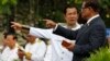 In this file photo taken on Nov. 9, 2017, Cambodia's Prime Minister Hun Sen, second from right, talks with Sar Kheng, right, deputy prime minister and minister of Ministry of Interior, as they wait to attend the Independence Day celebrations in Phnom Penh.