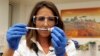 Dr Felicity Hartnell, who is a clinical research fellow at Oxford University, holds a vial of an experimental vaccine against Ebola in Oxford, England, Sept. 17, 2014.
