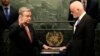The United Nations Secretary-General designate Antonio Guterres, left, is sworn in by Peter Thomson, president of the UN General Assembly, at U.N. headquarters, Dec. 12, 2016. 