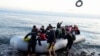 FILE - Migrants arrive at the village of Skala Sikaminias, on the Greek island of Lesbos, after crossing on a dinghy the Aegean sea from Turkey, March 2, 2020.