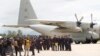 Thai Navy SEALs and military personnel take a group picture before they board a plane at the airport in Chiang Rai, northern Thailand, Thursday, July 12, 2018. 