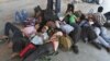 People from India's northeastern states, take a nap at a platform while waiting for the train to board back to their homes at a railway station in the southern Indian city of Chennai, August 17, 2012.
