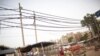 Potters rest on the roadside, under the overhead power cables at Gurgaon, on the outskirts of New Delhi June 17, 2012.