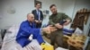 Ukrainian President Volodymyr Zelenskyy, right, and Netherland's caretaker Prime Minister Mark Rutte, center, pose for a photo with a wounded Ukrainian soldier in a hospital in Odesa, Ukraine, on Oct. 13, 2023. (Ukrainian Presidential Press Office via AP)