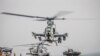 FILE - An AH-1Z Viper from the 11th Marine Expeditionary Unit prepares for takeoff aboard the amphibious assault ship USS Boxer as it transits the Strait of Hormuz, off Oman, in this U.S. Navy photo.