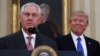 President Donald Trump smiles at Secretary of State Rex Tillerson after he was sworn in in the Oval Office of the White House in Washington, Feb. 1, 2017. 