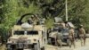 FILE - Afghan security forces prepare themselves during a battle with insurgents on the outskirts of Kunduz, Afghanistan, Aug. 21, 2016. 