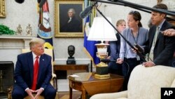 President Donald Trump talks to reporters in the Oval Office of the White House, in Washington, July 9, 2019.