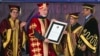 Afghan President Hamid Karzai receives an honorary degree from his Indian counterpart Pranab Mukherjee, second right, at the Lovely Professional University in Jalandhar, India, May 20, 2013.