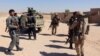 Afghan Special Forces and policemen prepare themselves for battle with the Taliban on the outskirts of Lashkar Gah capital of Helmand, Afghanistan, Oct. 10, 2016. 