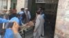 Injured man exits attack area on a stretcher after suicide bombers attacked a court in Charsadda, Pakistan, Feb. 21, 2017. (Photo: A. Momand / VOA Deewa Service)