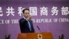 FILE - Chinese Ministry of Commerce spokesman Gao Feng gestures as journalists raise hands for questions during a press conference at the Ministry of Commerce in Beijing, April 6, 2018. 