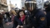 Protesters are pushed away by Spanish police officers during a 24-hour nationwide general strike in central Madrid November 14, 2012.