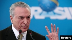 Brazil's interim President Michel Temer gestures during the inauguration ceremony of new presidents of state companies, at the Planalto Palace in Brasilia, June 1, 2016.