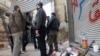 Free Syrian Army fighters stand by their weapons in the besieged area of Homs, March 9, 2013.