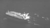 FILE - This still image from video released by the U.S. Navy shows the Panama-flagged oil tanker Niovi surrounded by Iranian Revolutionary Guard Corps vessels in the Strait of Hormuz, May 3, 2023.