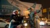 An airport security officer directs a motorcyclist at the entrance to the Benazir Bhutto International Airport in Islamabad, Pakistan, Dec. 7, 2016. 