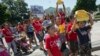 Demonstrators march following a news conference of immigrant families and children's advocates responding to President Barack Obama's position on the crisis of unaccompanied children and families illegally entering the US, in front of the White House in W