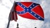 FILE - A protester waves a Confederate battle flag in front of the South Carolina statehouse, July 9, 2015, in Columbia, South Carolina. 