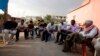 Turkish Kurdish men chat in the village of Doruklu, in the border town of Silopi, near the Turkish-Iraqi border, July 5, 2014. 