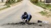 FILE - A Syrian man collects samples from the site of a suspected toxic gas attack in Khan Sheikhun, in Syria’s northwestern Idlib province, April 5, 2017.